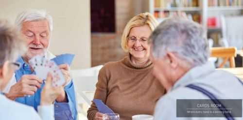 A group of older adults sitting on a couch in the Cards Room at Signature Global Titanium Sector 71, Gurgaon.