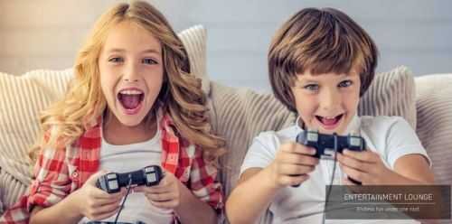 Two kids engrossed in video games on a couch in an entertainment lounge at Signature Global Sector 71, Gurgaon.