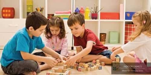 Children playing with blocks on the floor at Signature Global Sector 71 Gurgaon.